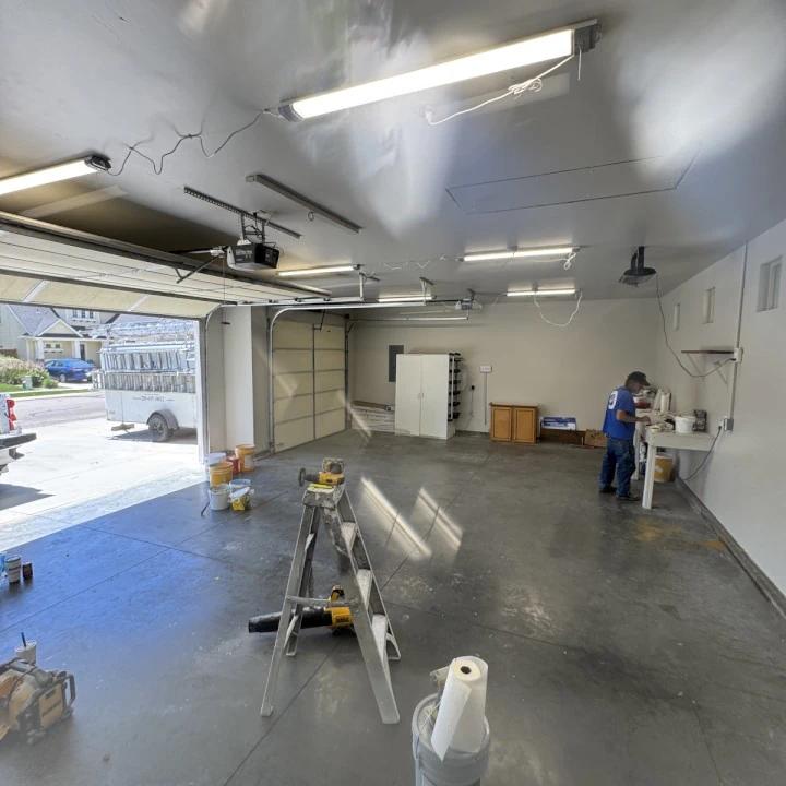 JLS Painting crew hard at work inside a garage