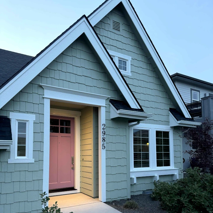 A cozy green and pink house painted by JLS Painting