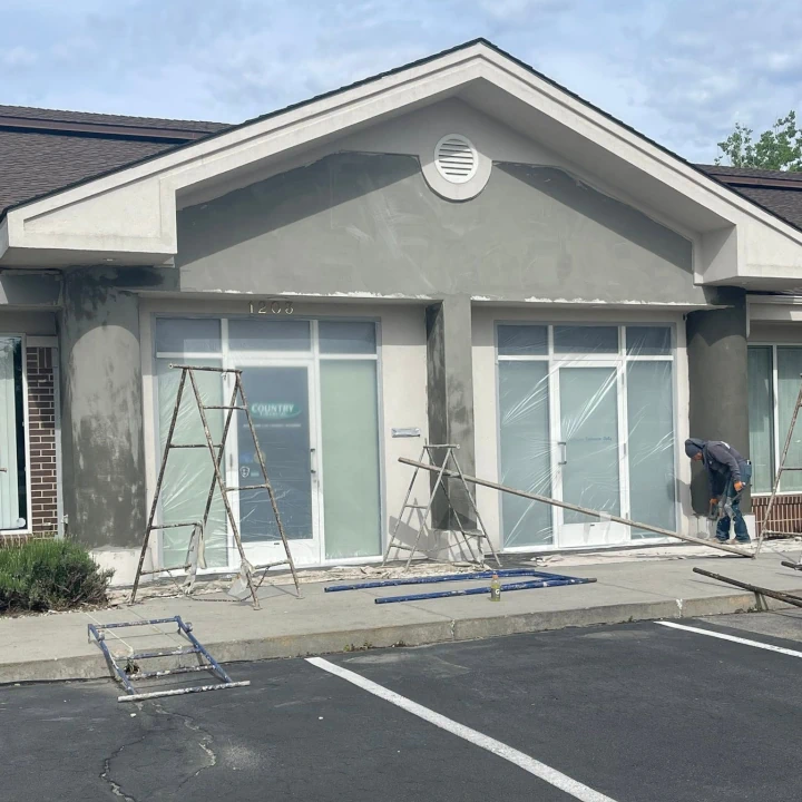 The storefront of an office building prepped for painting