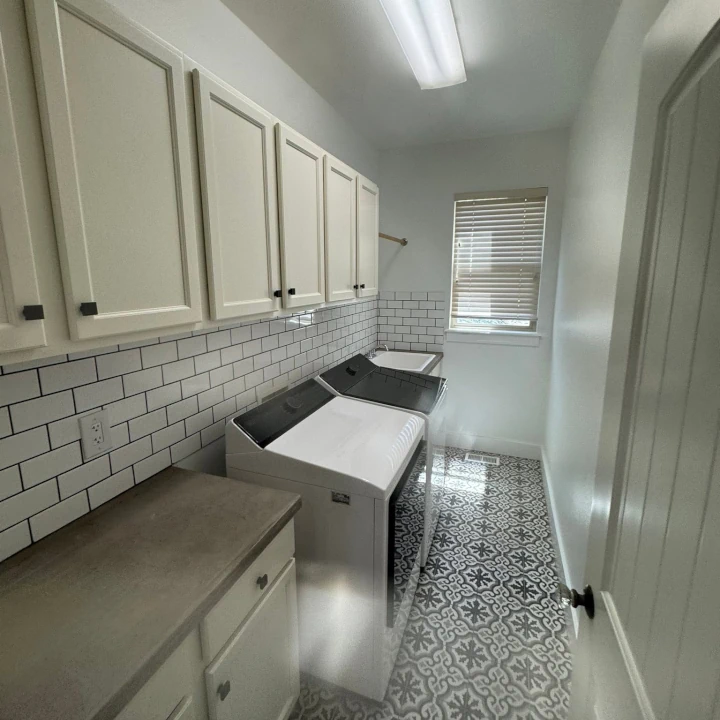 A white laundry room interior painted and refinished by JLS Painting